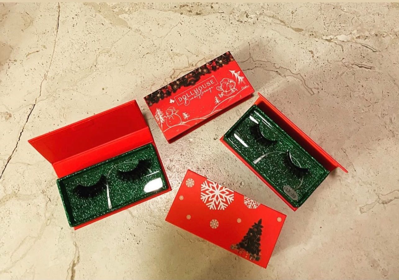 Dollhouse Christmas lash collection: red and green holiday boxes with three lash pairs